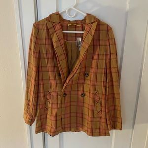 Orange Anthropologie blazer.